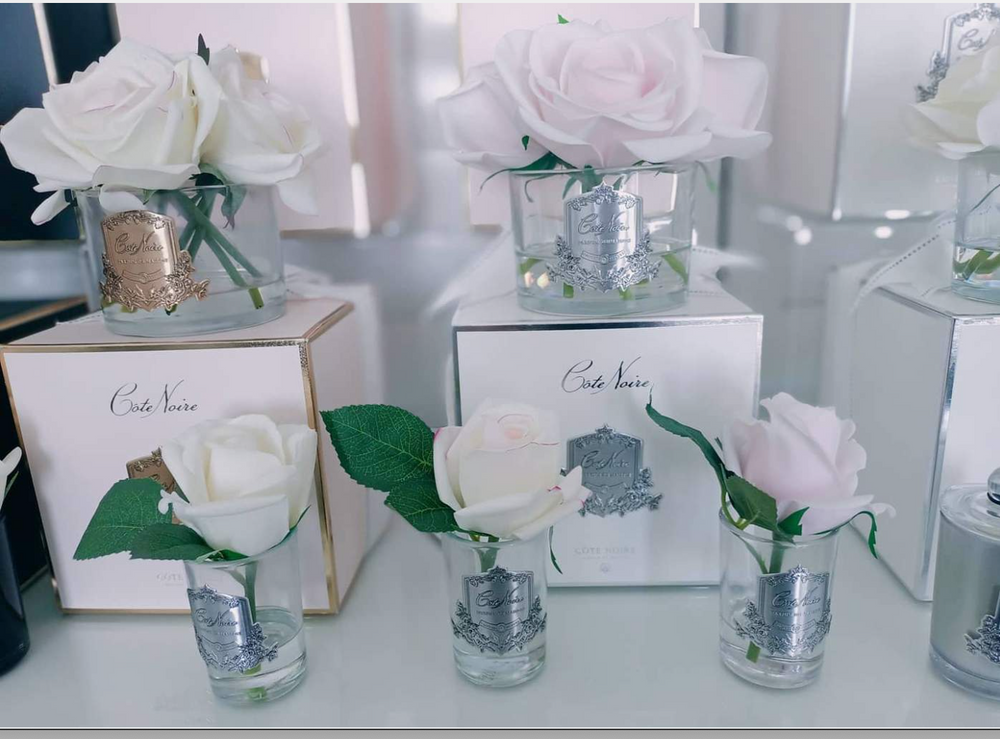 
                  
                    A display of luxury realtouch roses at Natashas skin Spa with boxes and pretty crests on the vases
                  
                